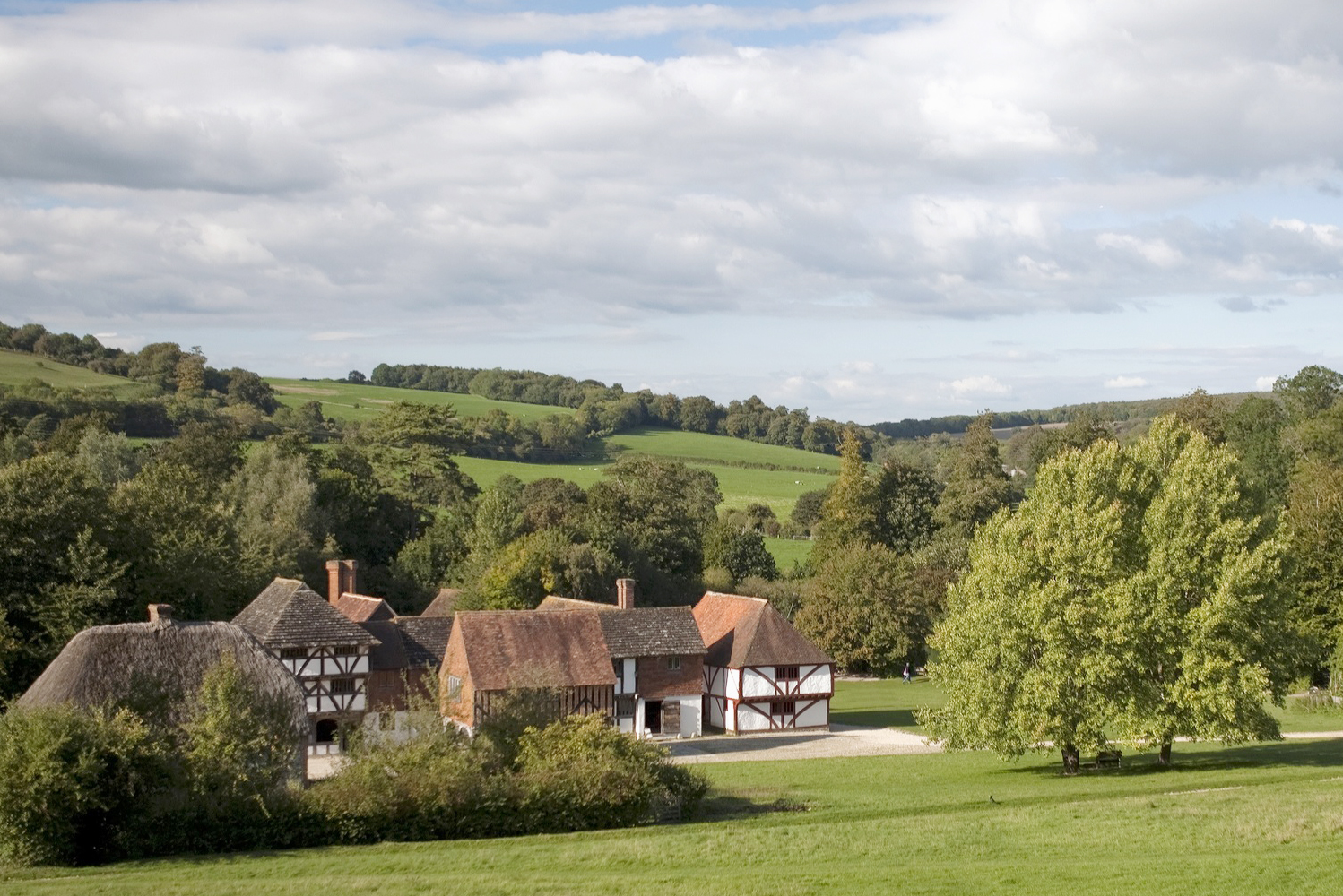 Grounds of the Weald and Downland Museum, Singleton showing medieval buildings within the green rolling countryside of the South Downs. Just one of the arts, history and culture attractions nearby