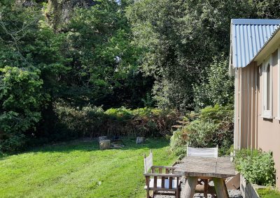 St Bride's garden has a campfire with cooking equipment and logs to sit on, as well as a picnic table and director's chairs. Two sides of the garden of this shepherds hut with ensuite are edged by the surrounding ancient woodland